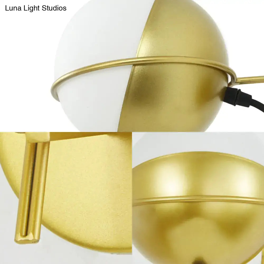 Modern yellow globe wall sconce featuring a gold and white glass globe with a sleek matte finish for bedroom use