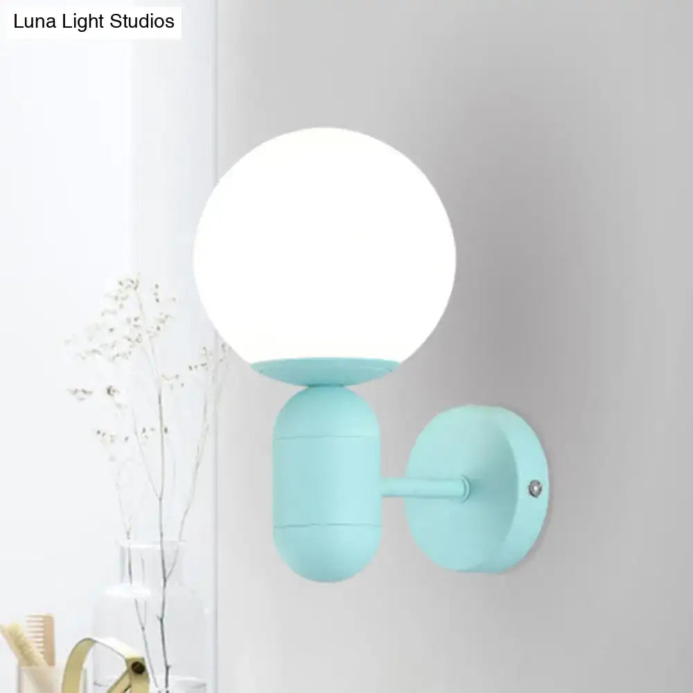 Modern pastel blue spherical wall sconce with frosted glass globe and matte metal fixture suitable for 220v-240v and 110v-120v