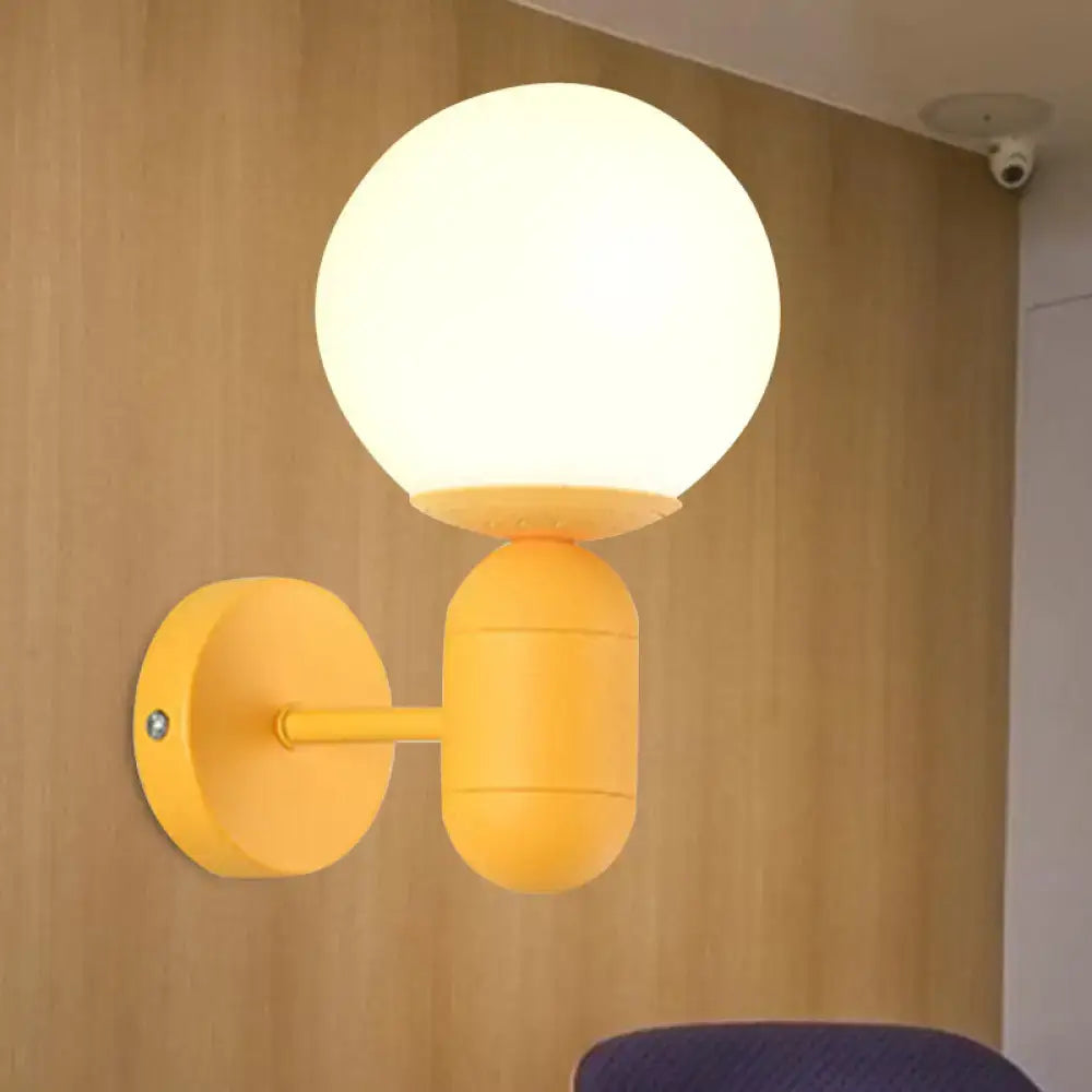A bright yellow modern metal fixture wall lamp with frosted glass orb shade for 220v-240v installation