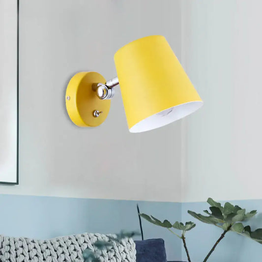 Bright yellow conical metal shade sconce light with matte finish and chrome accents for modern bedroom use