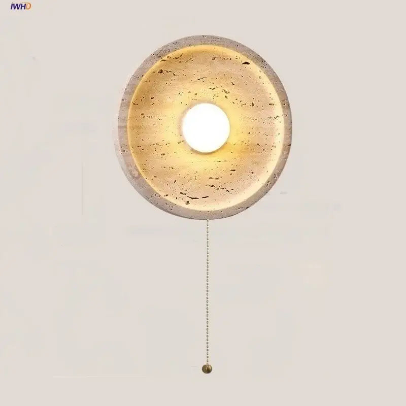 Modern yellow stone led wall lamp with circular concrete design warm textured interior and brass pull chain for bedroom