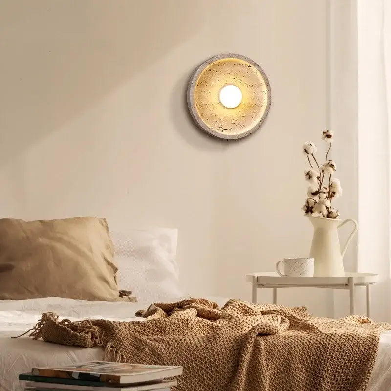 Modern yellow stone led wall lamp with textured speckled concrete finish and warm glowing center for bedroom lighting