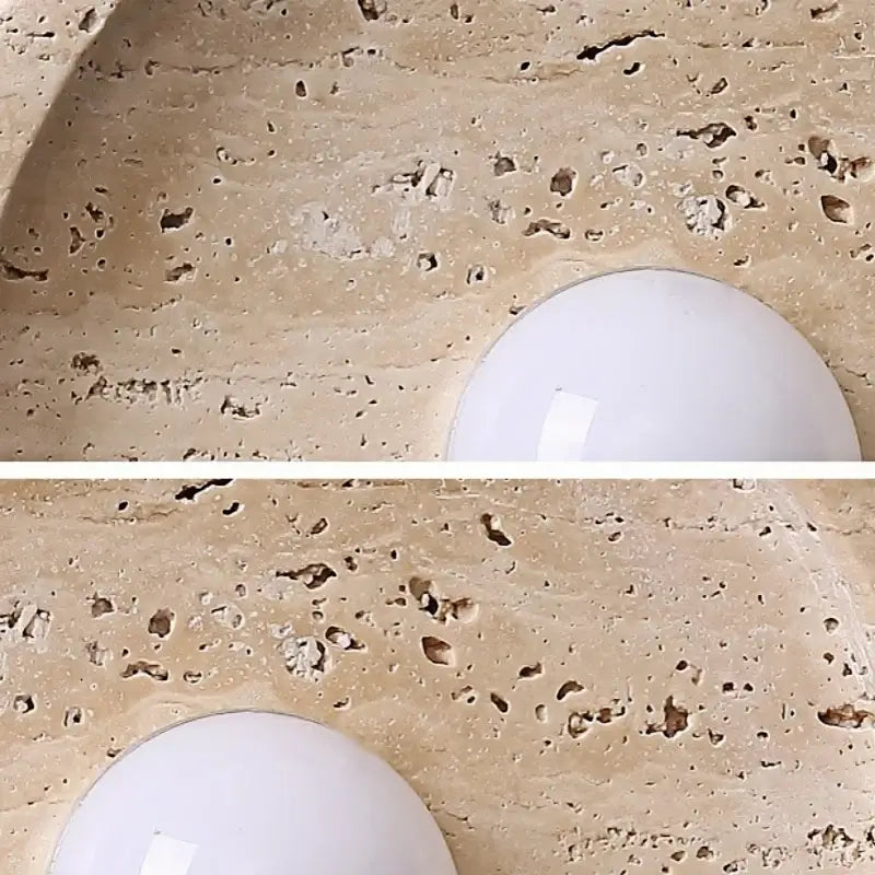 Modern yellow stone led wall lamp with a white round led wall lamp mounted on textured beige stone countertop