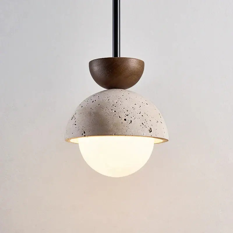Modern yellow travertine led pendant light with textured concrete dome dark wood cap and frosted glass globe for kitchen island