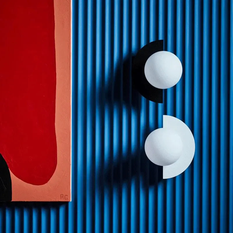 Modern yellow and white decorbites kids macaron led wall lamp with white spherical sconces on blue corrugated surface