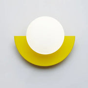 Minimalist modern wall lamp featuring a white circular lamp head on a yellow semi-circular base decorbites kids macaron led