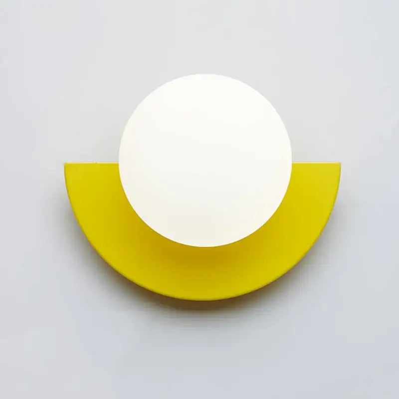 Minimalist modern wall lamp featuring a white circular lamp head on a yellow semi-circular base decorbites kids macaron led
