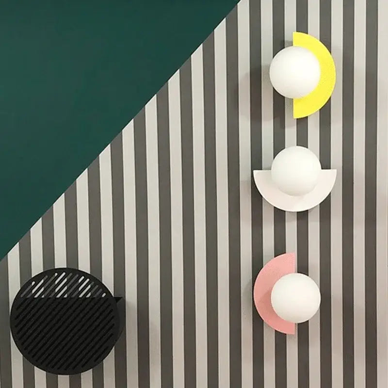 Modern yellow and white kids macaron led wall lamp featuring spherical globes on colorful curved acrylic bases decorbites kids macaron