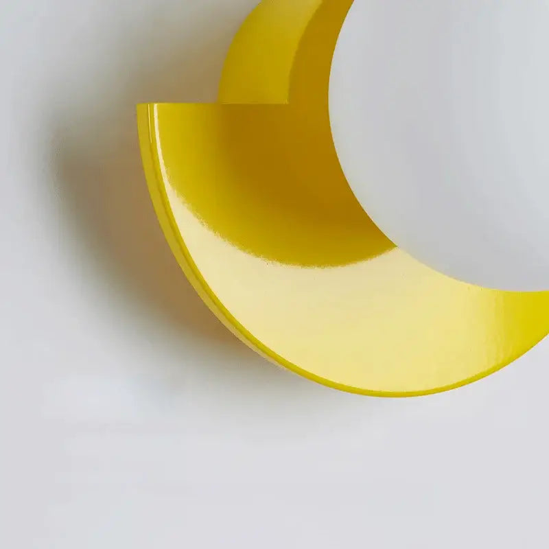 A sleek translucent yellow crescent wall lamp with glossy finish from decorbites kids macaron led bedroom sconce