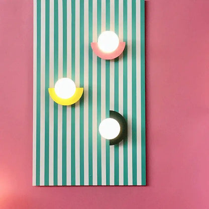 Three modern wall lamps with glowing white spheres and colorful acrylic bases in decorbites kids macaron led style