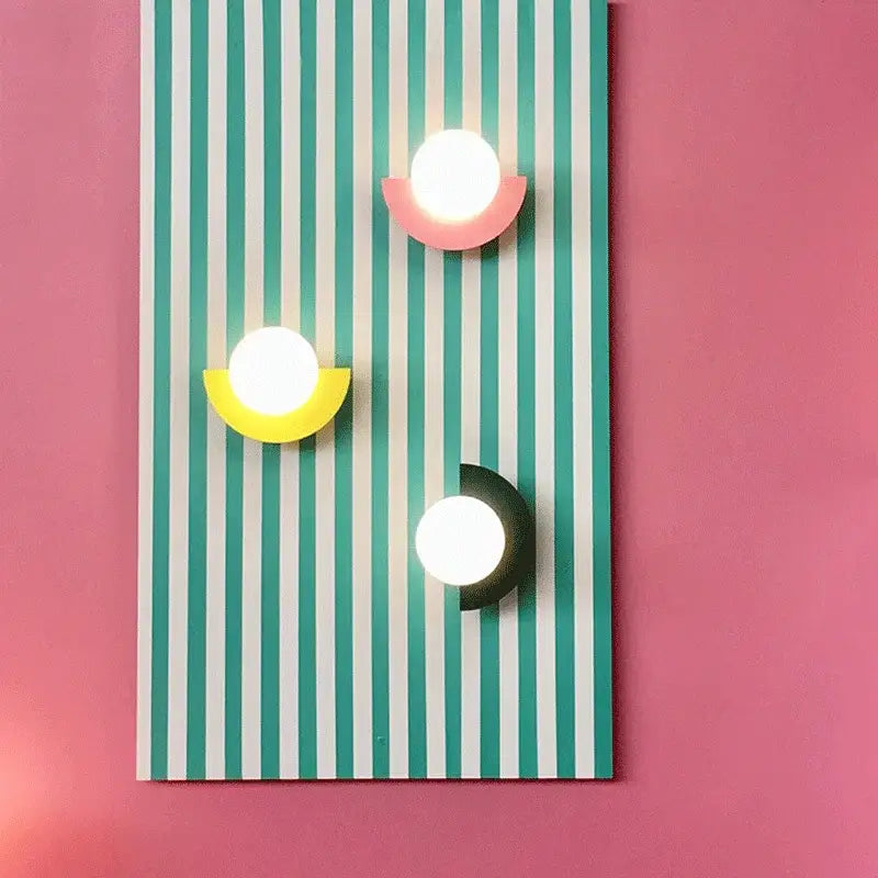 Three modern wall lamps with glowing white spheres and colorful acrylic bases in decorbites kids macaron led style