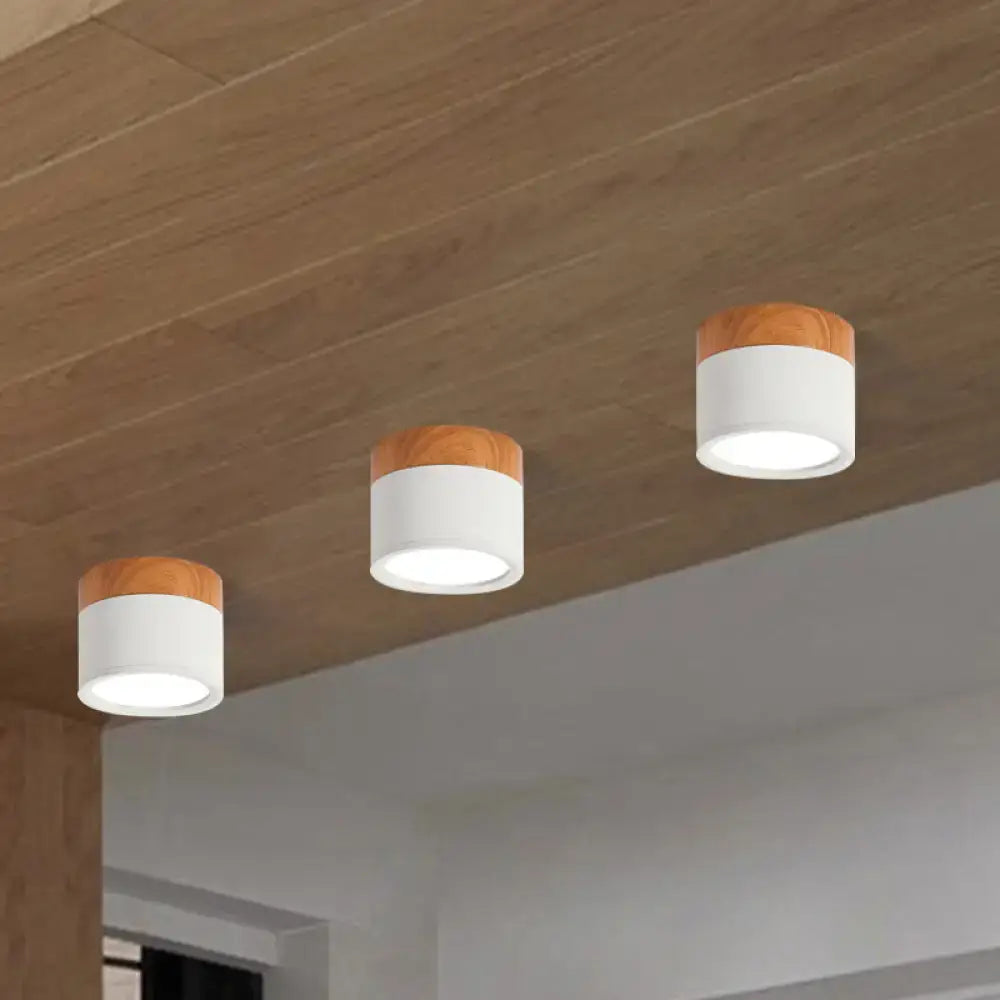 Three modern white cylindrical flush mount ceiling lights with wooden tops for kitchen bar by decorbites™