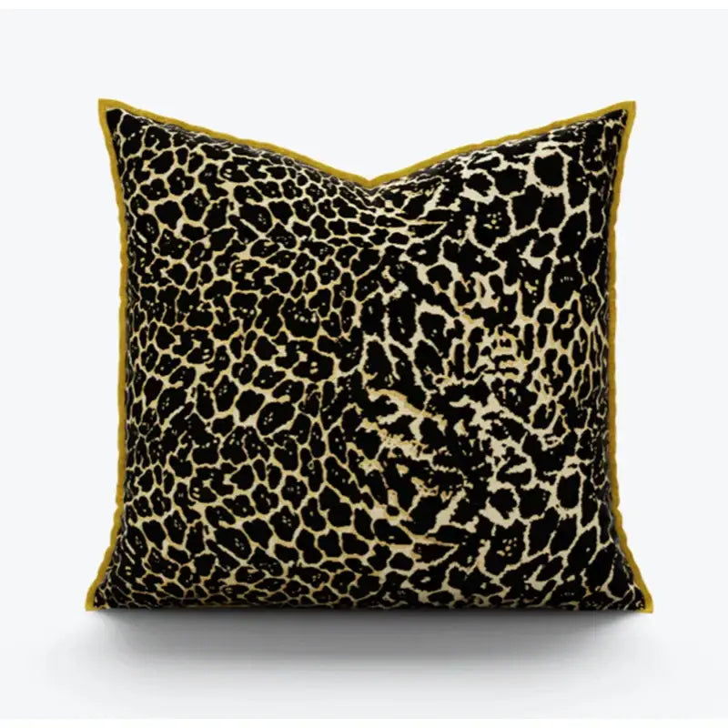 Square pillow cover with bold black and beige leopard print fabric and plush mustard-yellow velvet trim for decorbites gold zebra decor