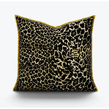 Square pillow cover with bold black and beige leopard print fabric and mustard-yellow velvet trim for decorbites gold zebra decor