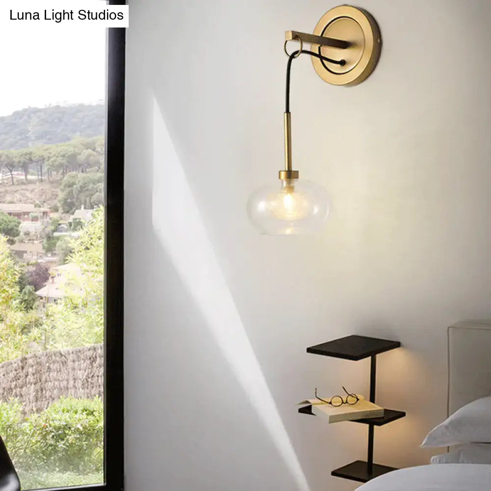 Gold-toned modernist amber white glass wall sconce with clear globe and black cord for bedroom drop lamp lighting