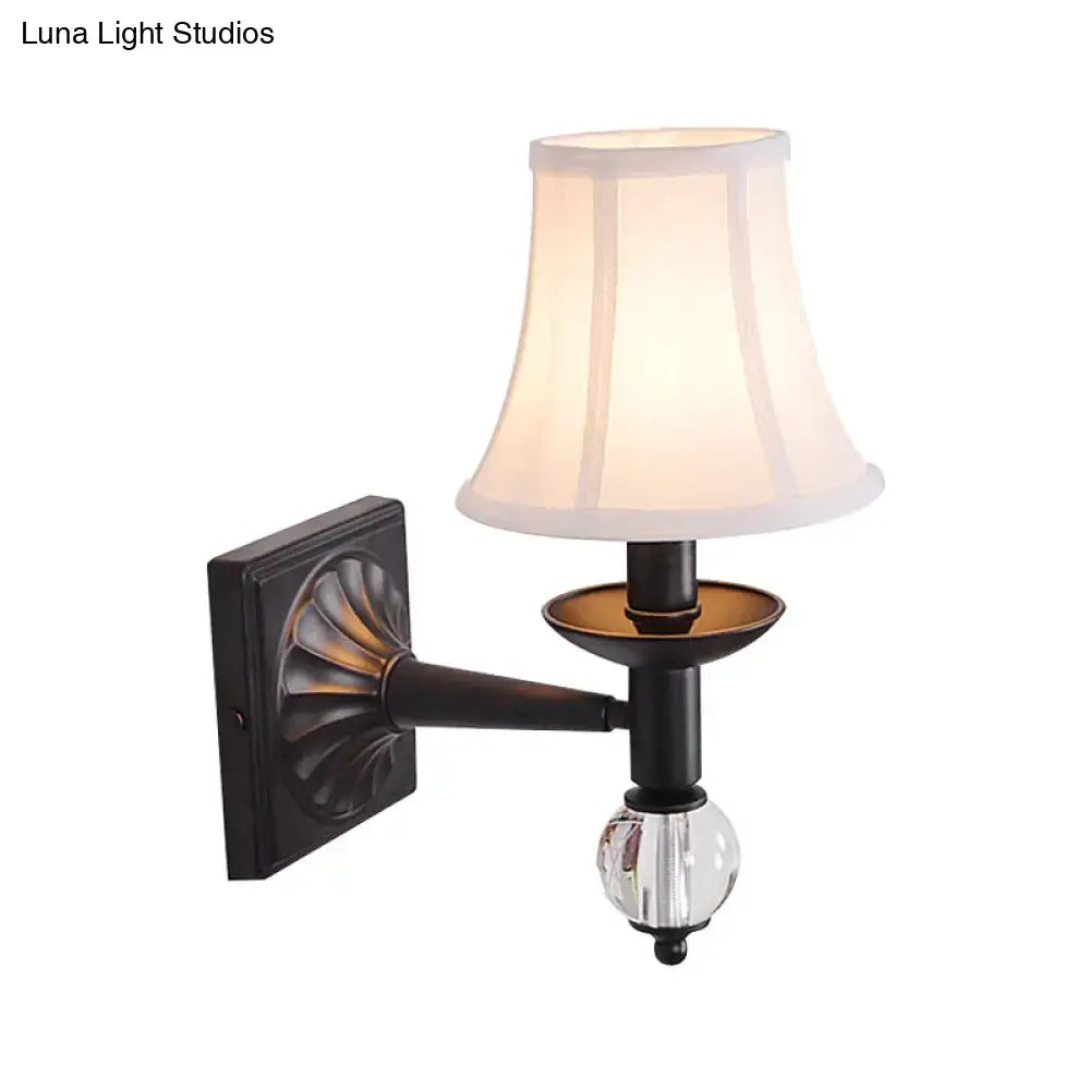 Antique bronze-finished modernist bell wall sconce with clear crystal globe and soft white fabric shade for bedroom use