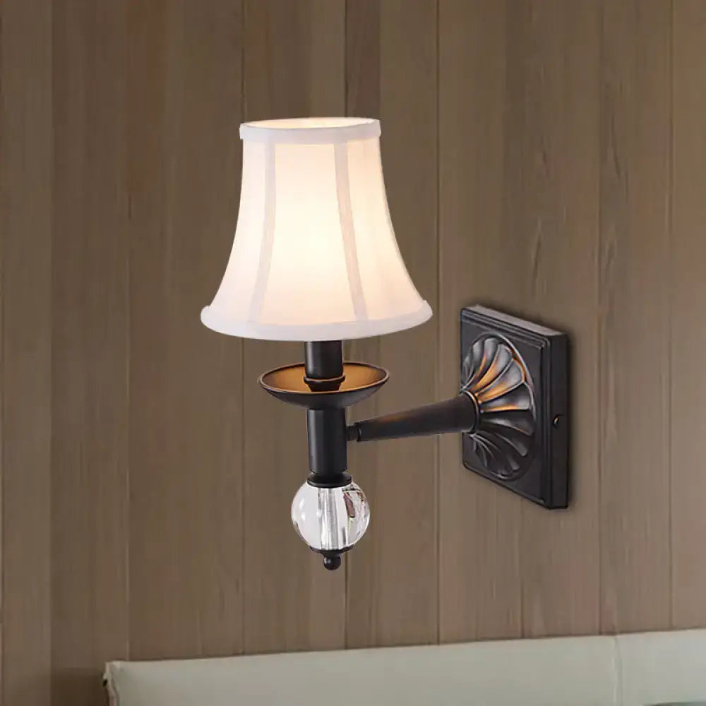 A classic black wrought iron modernist bell wall light with white fabric shade and clear crystal globe accent for bedroom