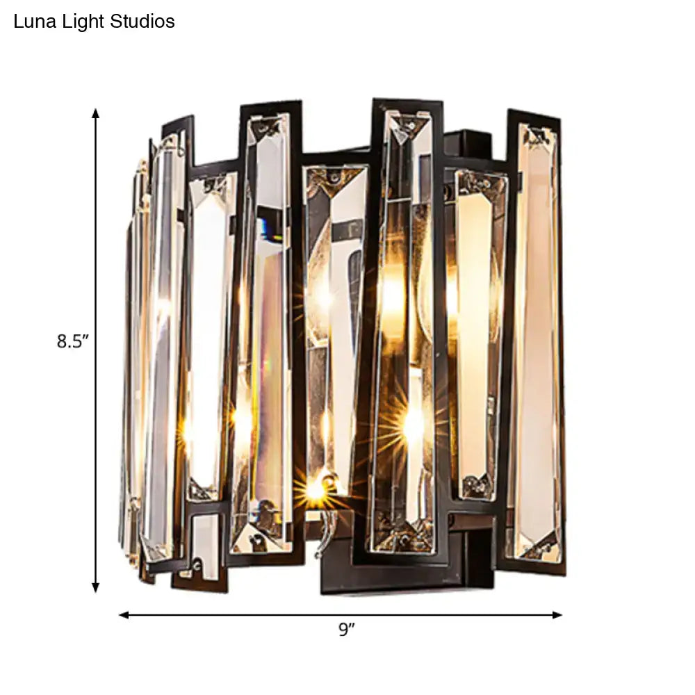 Modernist wall lamp with black finish and vertical crystal bars refracting warm light for corridor lighting