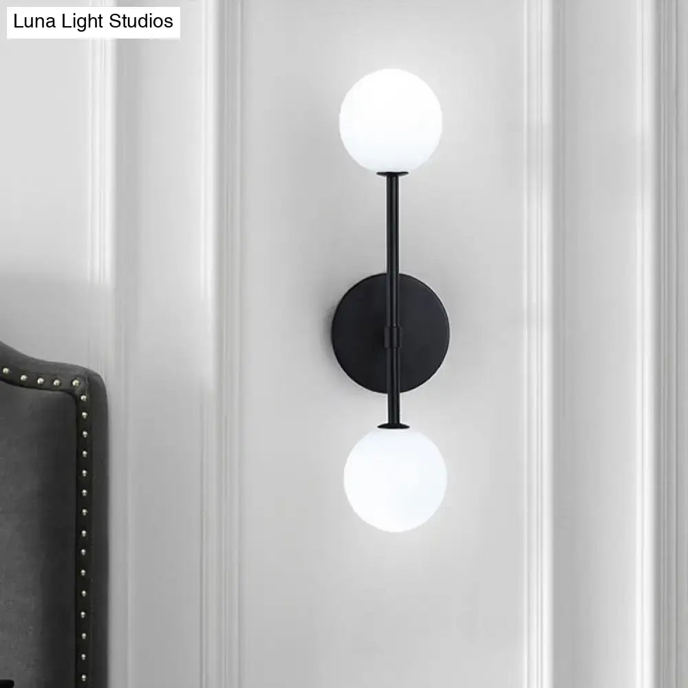 Modernist black gold metal wall sconce with double frosted glass globe shades for living room lighting