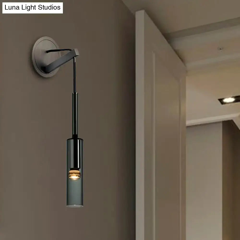 Modernist black metal wall sconce with cylindrical glass shade and LED crystal tube for bedroom lighting