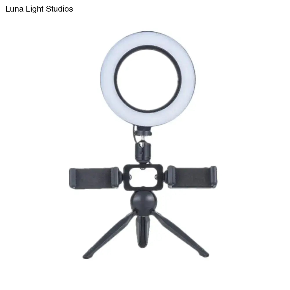 Black tripod-mounted led ring light with mobile phone support and adjustable stand for bedroom wall light use