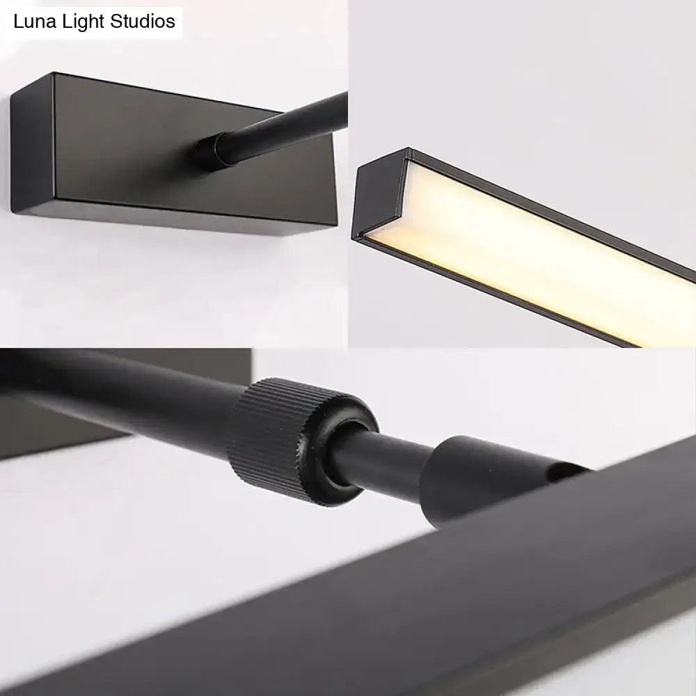 Modernist black metal linear vanity sconce with rectangular housing and adjustable arm for bathroom lighting