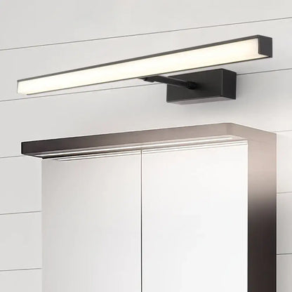 Modernist black and silver metal linear vanity sconce with sleek minimalist led design mounted above white cabinet