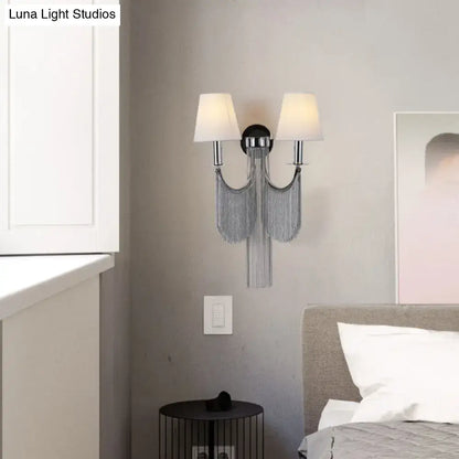 Chrome finished modernist wall sconce with two white fabric shades and silver chain fringe for e12 or e14 bulbs