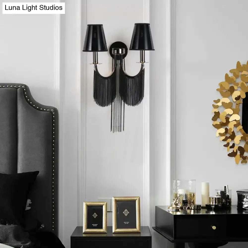 Modernist black and silver tassel wall sconce with e12 light featuring black fringe and two conical shades