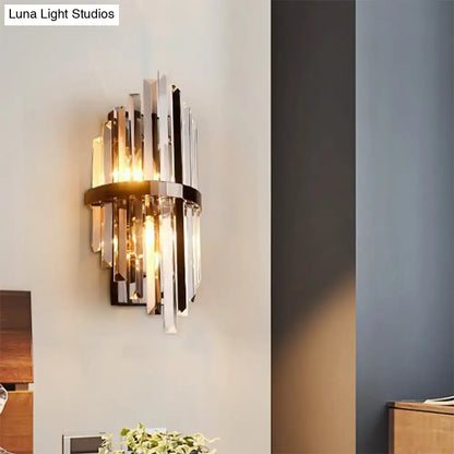 Modernist brass and clear crystal prism wall lamp with vertical crystal prism sconce and sleek black frame