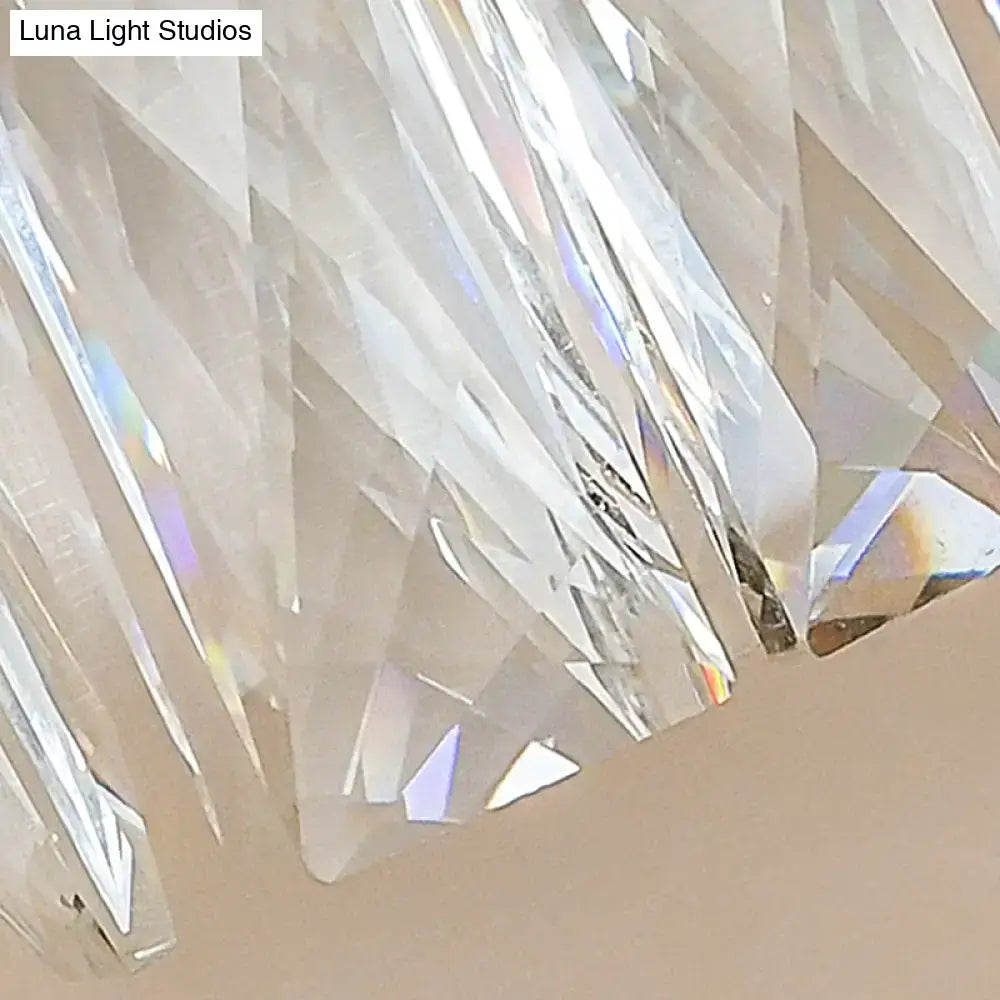 Modernist brass wall light with clear faceted prismatic crystal arms for elegant living room lighting