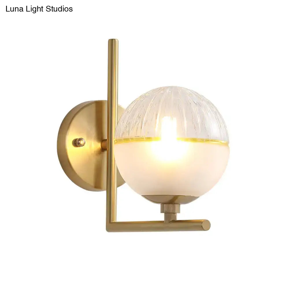 Modernist brass direct wired electric wall sconce with frosted glass and amber two-toned textured globe light fixture