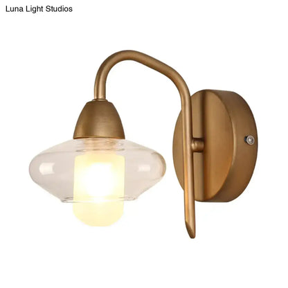 Antique brass wall lamp with clear glass shade and exposed bulb base modernist bedroom sconce design
