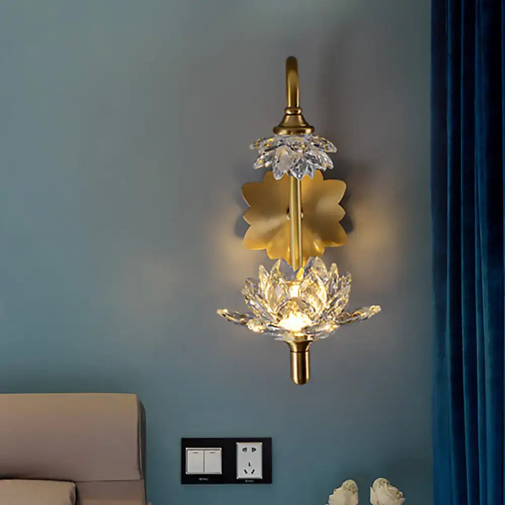 Modernist brass finish wall sconce with gold-toned crystal shade lotus flower design and central illuminated bloom