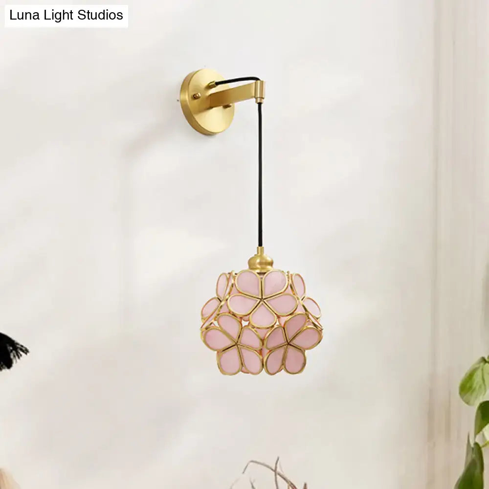 A modernist brass floral glass bulb bedside sconce with delicate light pink and clear cherry blossom pendant light