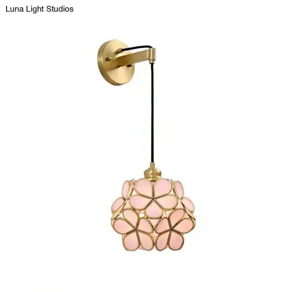 Modernist brass floral glass bulb bedside sconce with light pink and clear petals and brass wall mount
