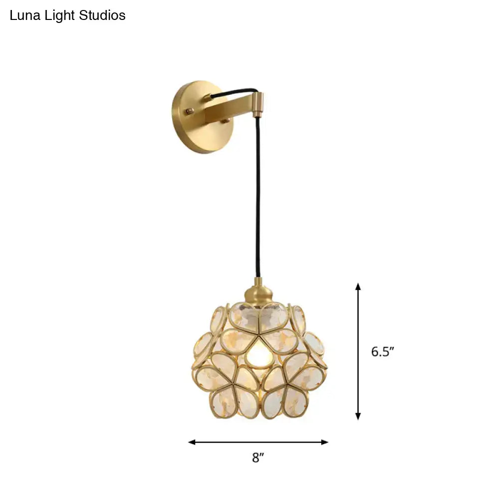 Modernist brass bulb bedside sconce with light pink floral glass shade made of translucent mother-of-pearl segments