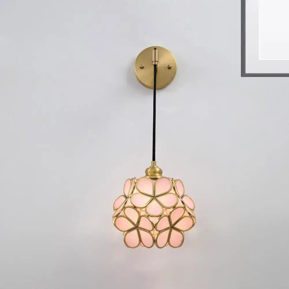 Modernist brass floral glass bulb bedside sconce with light pink handcrafted petals and black cord in a spherical bloom