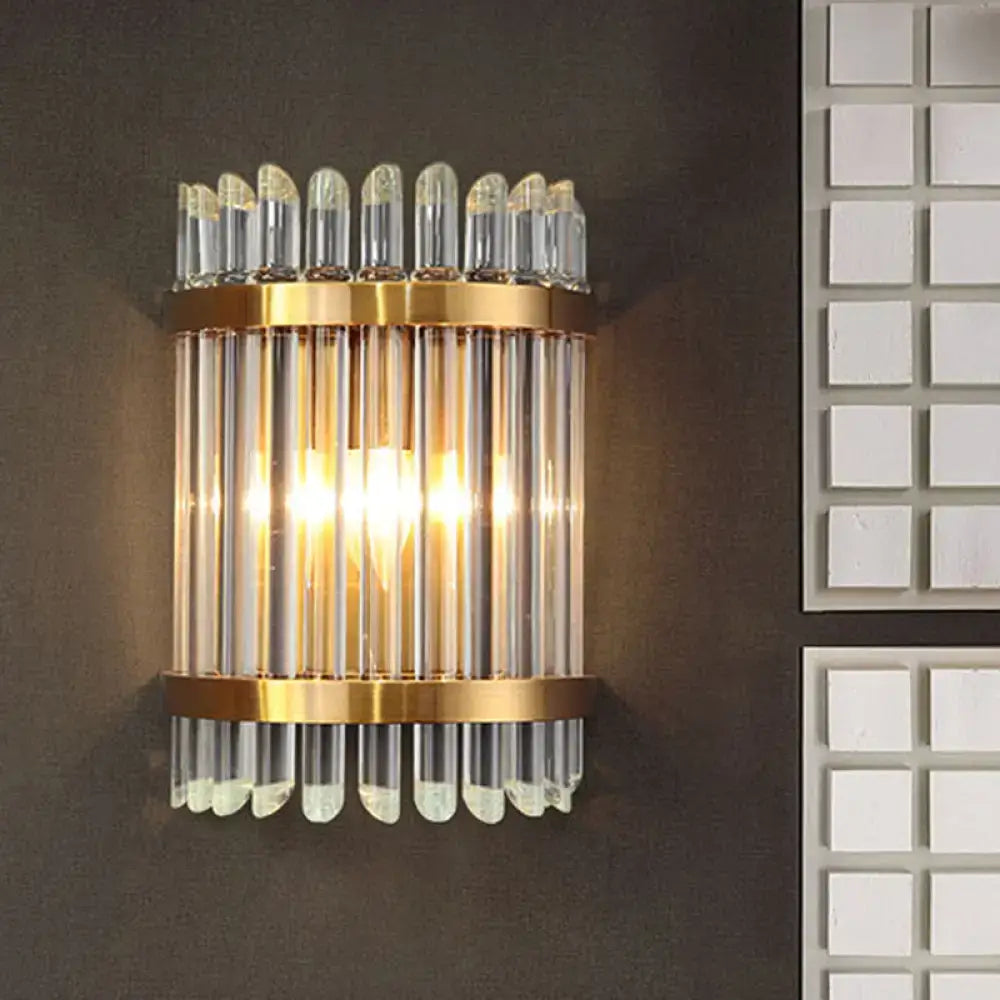 Modernist clear crystal wall sconce with gold finish and vertical glass tubes for elegant living room lighting