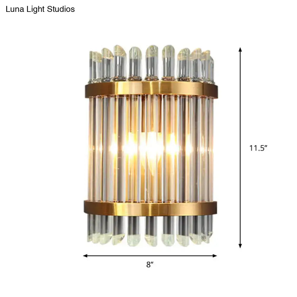Modernist gold finish wall sconce with vertical glass tubes and clear crystal accents for living room lighting