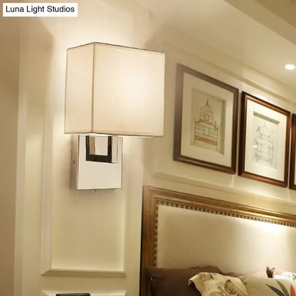 Modernist gold and beige sconce light fixture with white fabric shade and chrome base for bedroom wall lighting