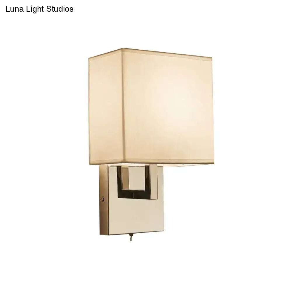 Modernist gold and beige sconce light fixture with brushed brass finish and soft fabric shade for bedroom wall lighting
