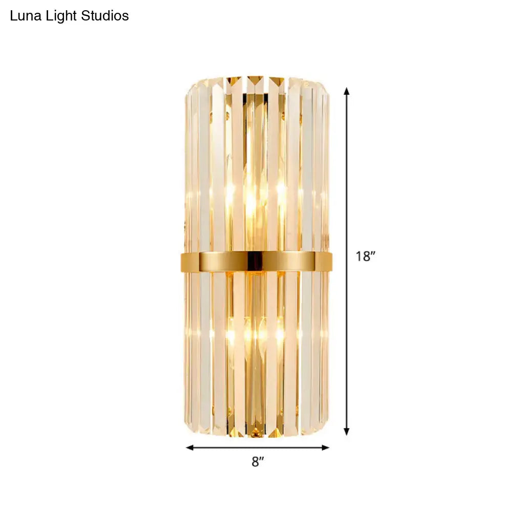 Modernist gold wall lighting fixture with vertical clear crystal prisms and central metallic band for cylinder wall lighting