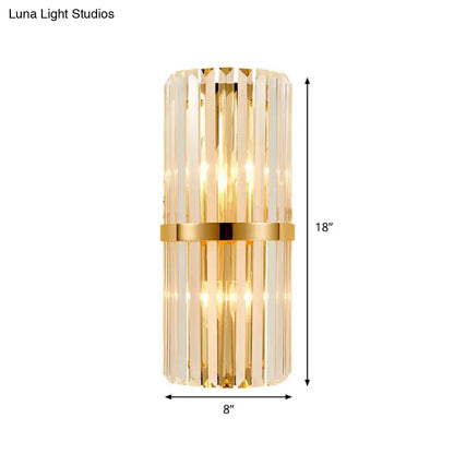 Modernist gold wall lighting fixture with vertical clear crystal prisms and central metallic band for cylinder wall lighting