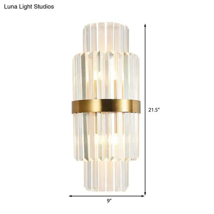 A modernist gold and clear crystal cylinder wall lighting fixture with stacked faceted rods for living room use