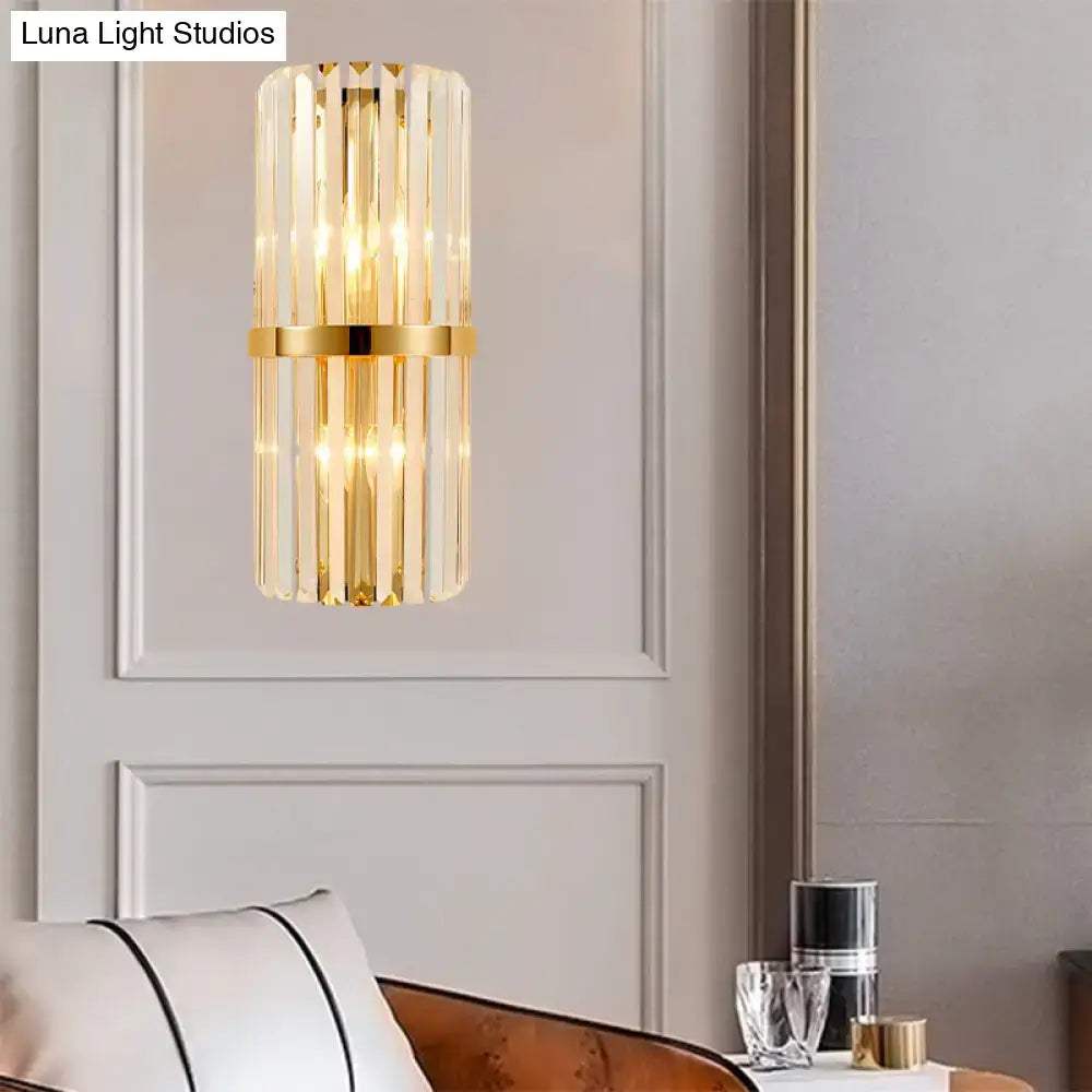 Elegant gold-toned modernist cylinder wall lighting features vertical crystal rods and a central brass band for living room use