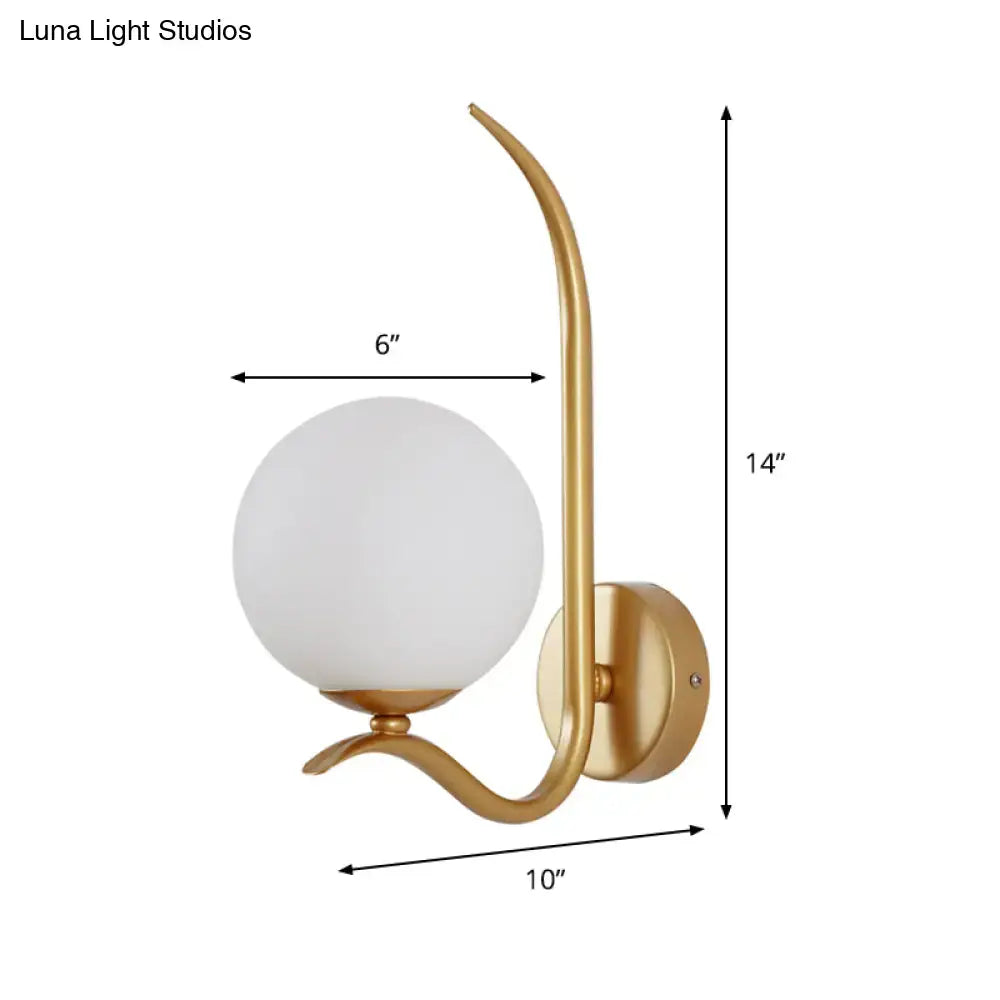 Modernist gold-toned sconce light with elegant curved arm and frosted white glass globe suitable for 220v-240v use