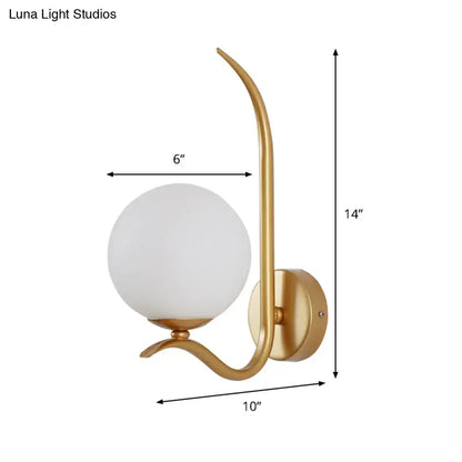 Modernist gold-toned sconce light with elegant curved arm and frosted white glass globe suitable for 220v-240v use