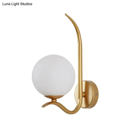 Modernist gold-toned sconce light with white frosted glass globe and curved metal arm for bedroom 220v-240v