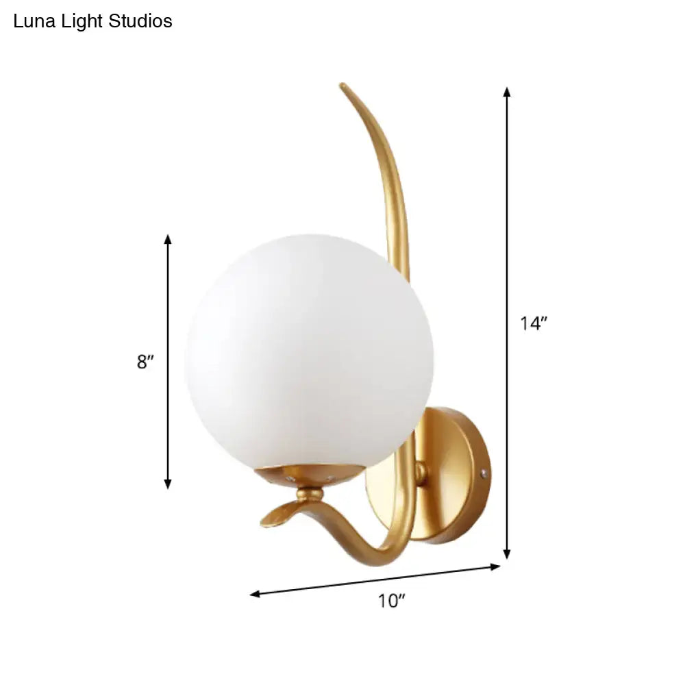 Modernist gold sconce light with white glass shade and curved metal arms suitable for 220v-240v bedroom use